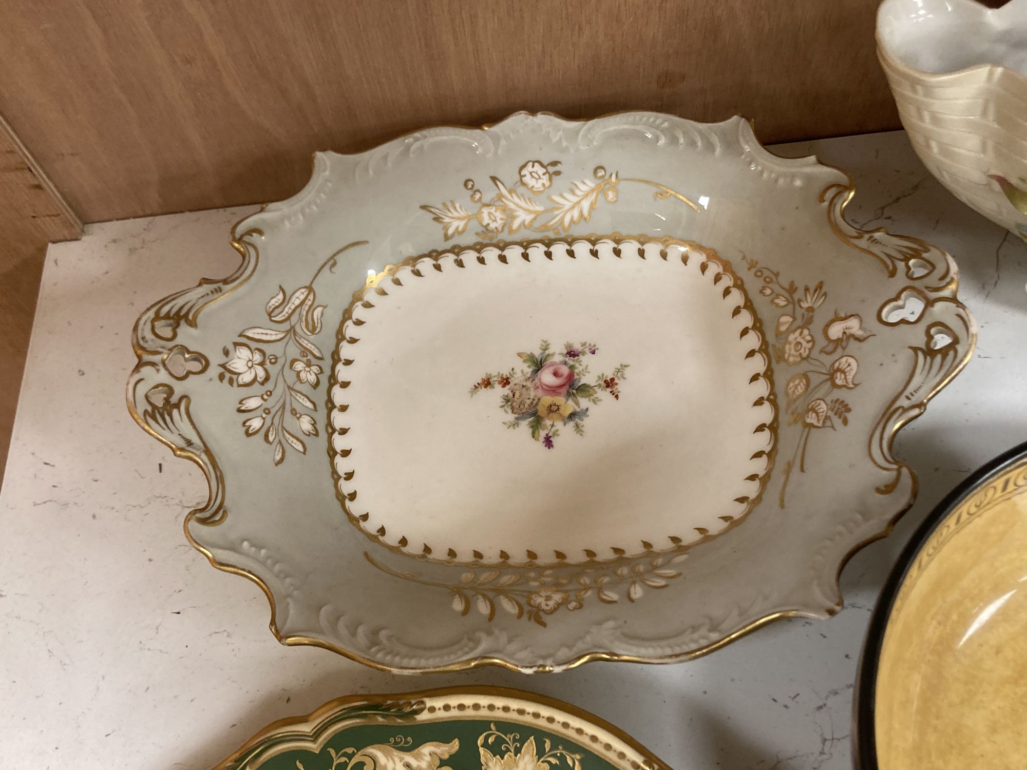 A Continental porcelain shaped oval posy basket encrusted with carnations and sundry ceramics,